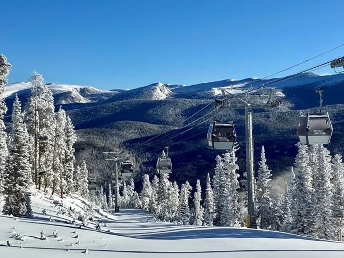 This exterior image captures ski lift gondolas gliding over snow-covered slopes, with distant mountains and evergreen trees completing the winter scene. The environment is serene yet invigorating, perfectly embodying the thrill and beauty of a ski resort in winter.